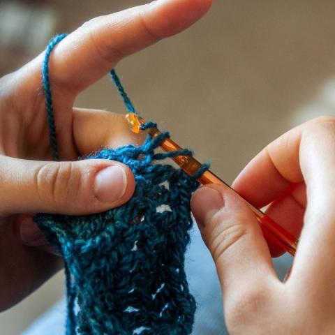 photo of hands crocheting