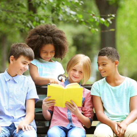 photo of group of tweens reading