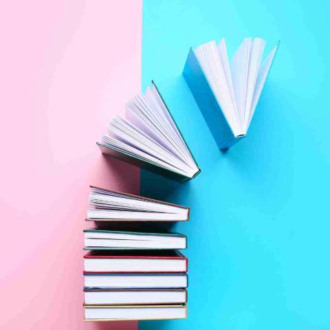 stack of books opening with bright background
