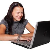 photo of teen using laptop