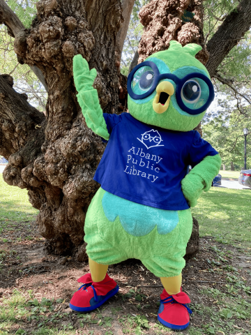Bleecker the Owl standing by a tree