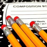 photo of composition book and pencils