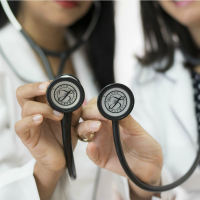 photo of hands holding up stethoscopes